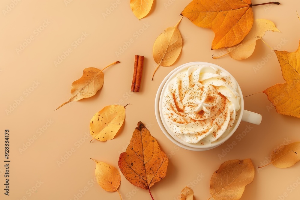 Autumn themed flat lay with pumpkin spice latte cinnamon leaves on orange background for logo design Autumn themed flat lay with pumpkin spice latte cinnamon leaves on orange background for logo design