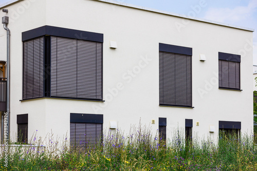 Roller Blind Windows Outside. External Blinds of Modern Building Apartment. Window Shutters Outdoor. Sun Protection Blinds.