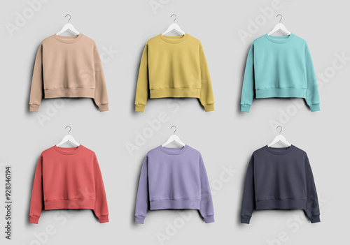 Mockup of colorful crop sweatshirt on hanger, women's casual clothing with round neck, isolated on background, front view.