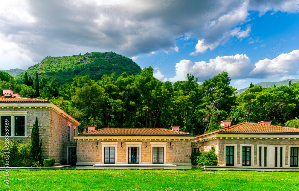 green garden landscape of beautiful resort with three nice buildings with windows, pool with water and green trees on background green garden landscape of beautiful resort with three nice buildings with windows, pool with water and green trees on background