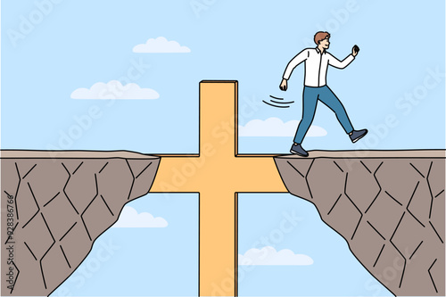 Religious business man overcomes obstacles thanks to christian crucifix and achieves goal. Guy corporate manager, is practicing catholic and achieves success in career using christian commandments.