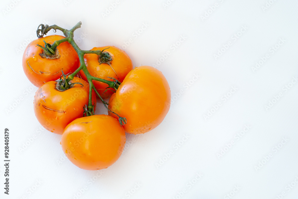 several yellow tomatoes on a white background with a shadow several yellow tomatoes on a white background with a shadow