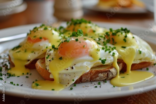 Tasty eggs benedict with rich hollandaise sauce