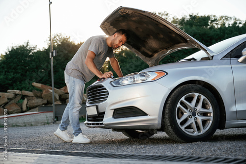 Problem, fixing and repairing the broken automobile. Man is with his car outdoors