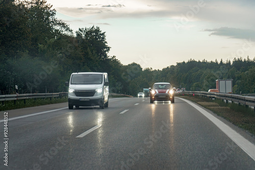 Cars with low beams on on the motorway in the evening. photo