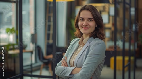 Confident businesswoman with crossed arms smiling in modern office, facing camera, embodying success in professional attire with sleek hairstyle. Free Download Confident businesswoman with crossed arms smiling in modern office, facing camera, embodying success in professional attire with sleek hairstyle. - GFXLoad