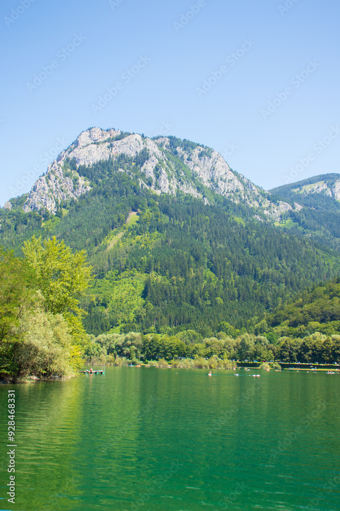 Fototapeta premium Tiebersee, nestled in the picturesque region of Styria, Austria, is a serene and idyllic alpine lake that offers a quintessential example of Austria’s natural beauty. 