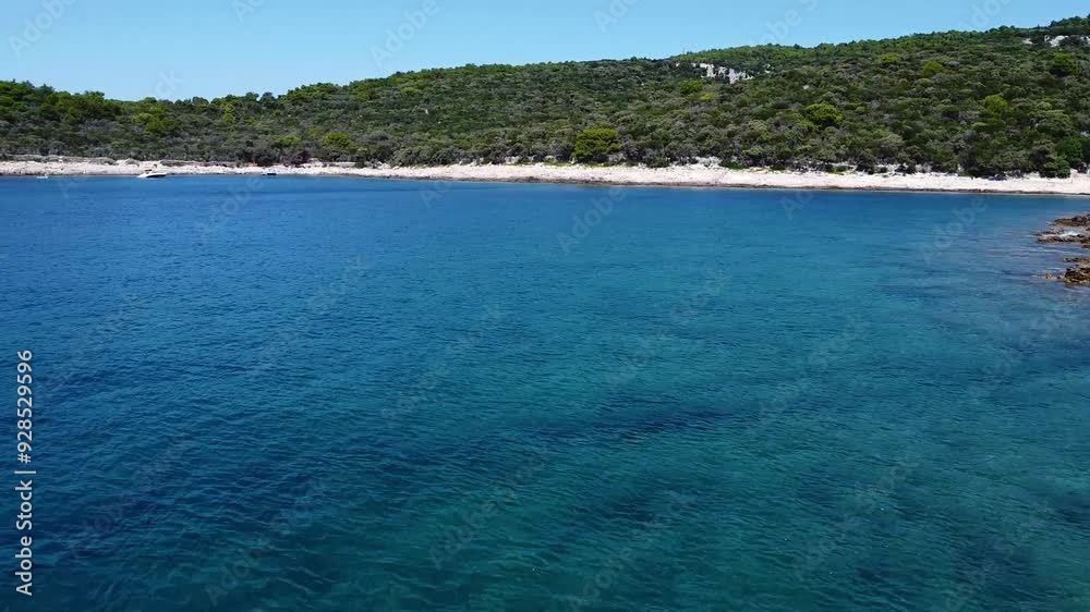 Drone flying backwards over rocky shores of Mali Losinj Island in Croatia Drone flying backwards over rocky shores of Mali Losinj Island in Croatia
