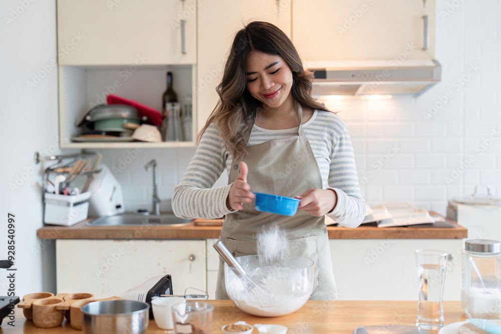 Smiling Woman Adding Ingredients for Baking in Home Kitchen Smiling Woman Adding Ingredients for Baking in Home Kitchen