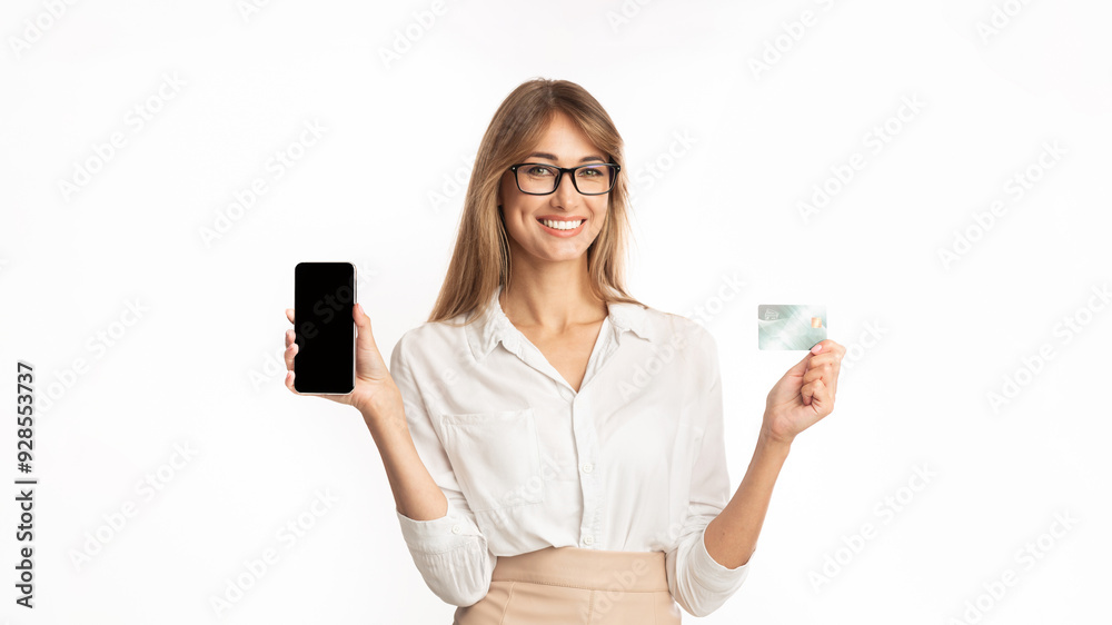 Online Payment. Smiling Business Woman Holding Cellphone And Credit Card Standing Over White Studio Background. Isolated Online Payment. Smiling Business Woman Holding Cellphone And Credit Card Standing Over White Studio Background. Isolated