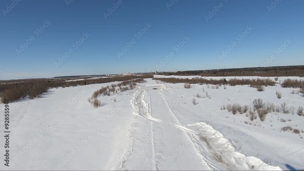 Frozen river winding through snowy landscape on sunny day. Surgut HMAO Frozen river winding through snowy landscape on sunny day. Surgut HMAO