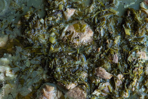 Traditional Georgian spring dish Chakapuli with meat, green plums and herb mix photo