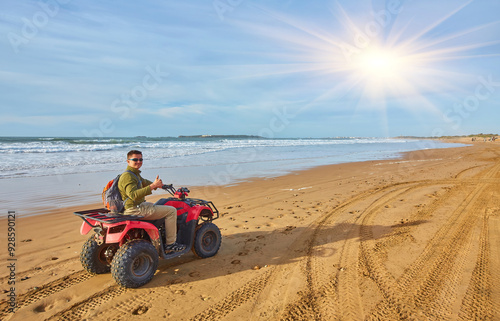 A young man explores the oceanfront on a quad bike near Essaouira,