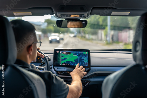 Obraz na płótnie Man touching screen of a GPS navigation system in his car.