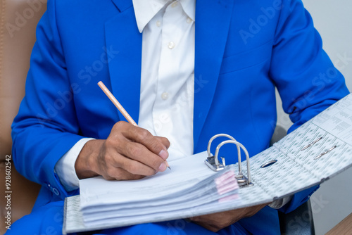 Business professional writing in a binder photo