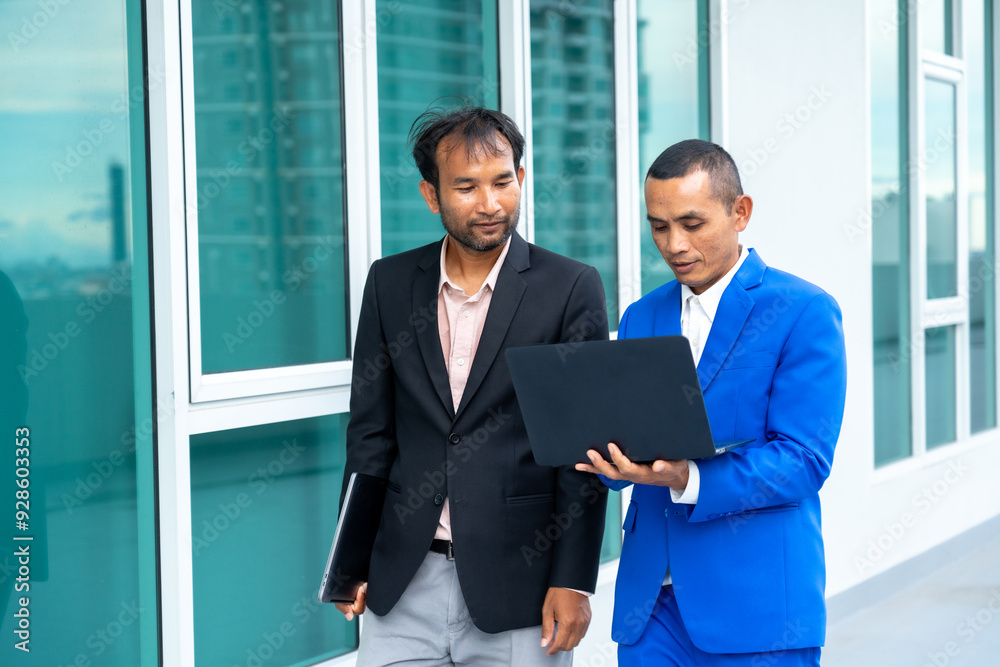 Two businessmen discussing work while walking Two businessmen discussing work while walking