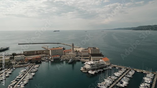 Ex Lighthouse La Lanterna In Trieste Harbour At Adriatic Sea In Molo Fratelli Bandiera, Trieste, Italy. Aerial Shot photo