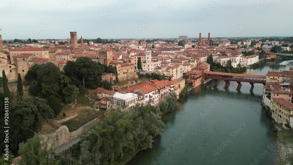 Ponte Vecchio (Ponte degli Alpini) With The Cityscape Of Bassano del Grappa In Italy. Aerial Drone Shot