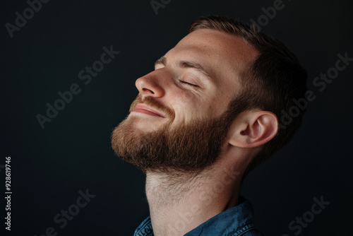 A close up of a man's face with his eyes closed