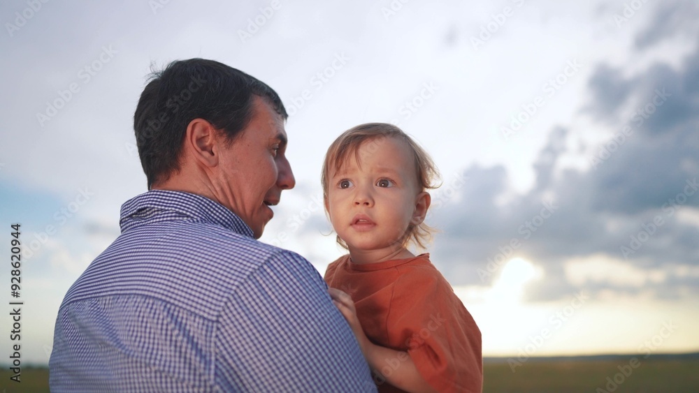 Father holds hands to a baby boy and toddler. Boy dream kid active concept. Father and child holds hands playing in the park. Father gives a baby to a child who is playing in the lifestyle park. Father holds hands to a baby boy and toddler. Boy dream kid active concept. Father and child holds hands playing in the park. Father gives a baby to a child who is playing in the lifestyle park.