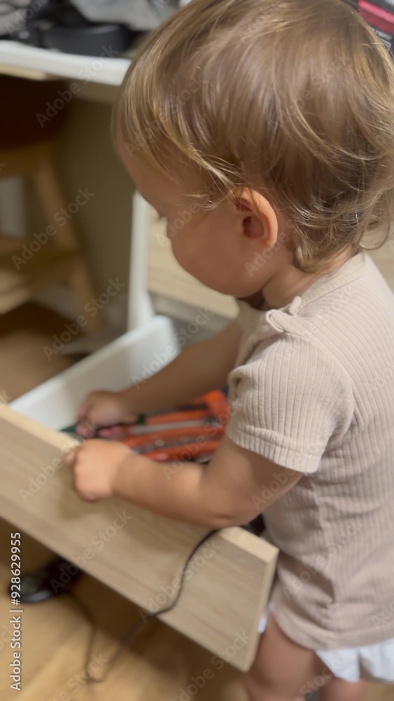 child twists drawer screwdriver. happy family kid dream concept. Toddler child twists screwdriver. a little boy with blond hair plays with tools in his father's office lifestyle child twists drawer screwdriver. happy family kid dream concept. Toddler child twists screwdriver. a little boy with blond hair plays with tools in his father's office lifestyle