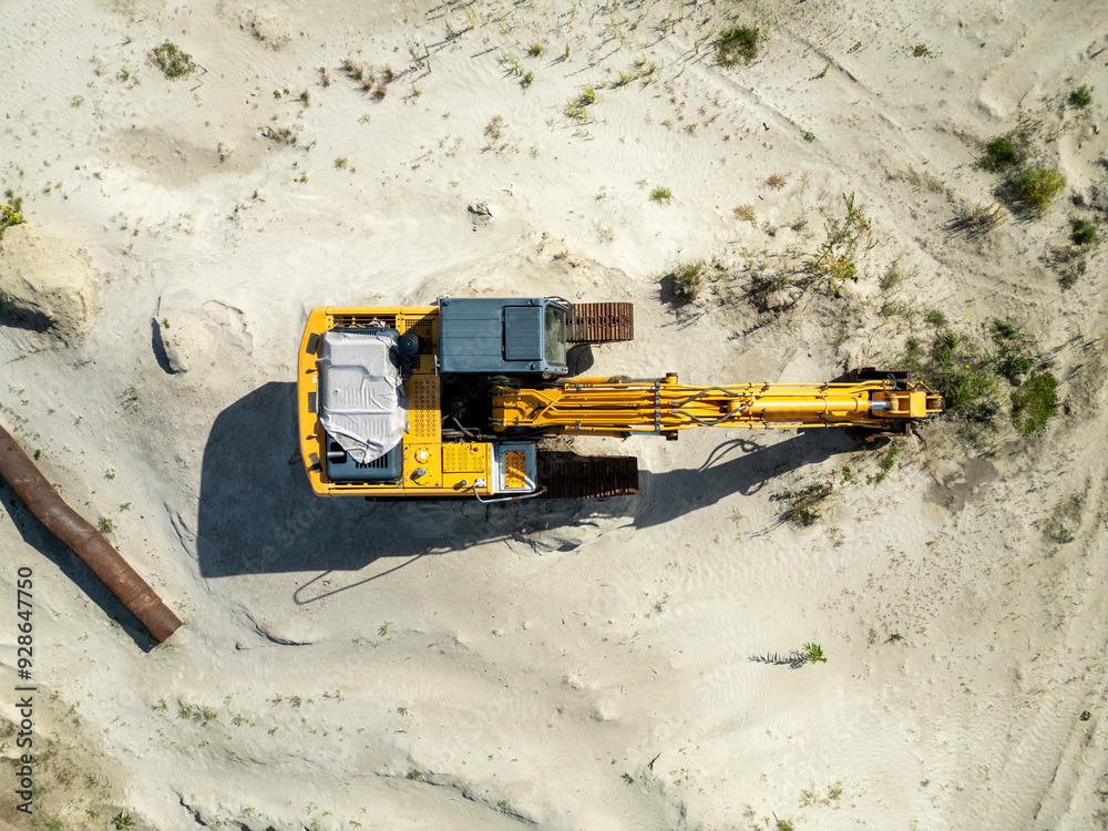Excavator on a Sandy Industrial Site, Top View Excavator on a Sandy Industrial Site, Top View