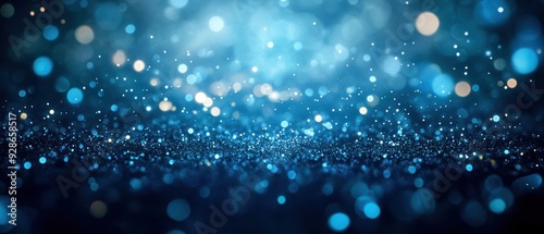 A captivating blue bokeh background featuring shimmering lights and particles that create a dreamy, ethereal atmosphere.