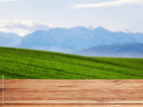 The empty wooden table top with background of hill landscape.