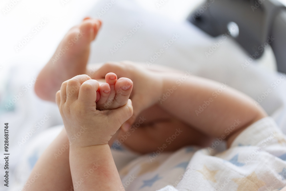 Newborn baby touching his feet. Selective focus. Newborn baby touching his feet. Selective focus.
