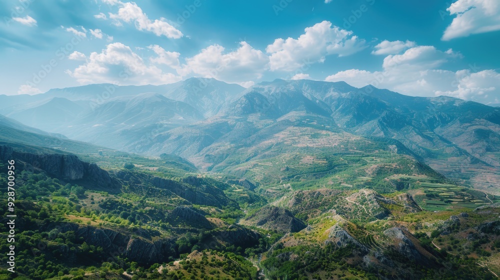Obraz premium A scenic view of a valley with mountains in the background, suitable for use in travel or outdoor adventure themes