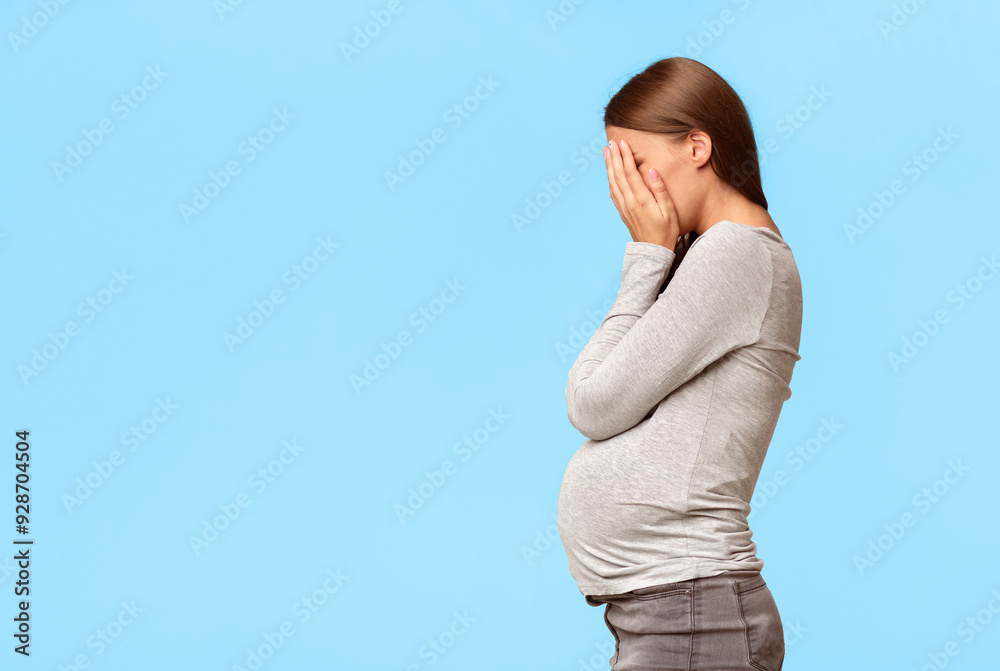 Depression. Frustrated Pregnant Woman Covering Face With Hands Standing Over Gray Studio Background. Free Space
