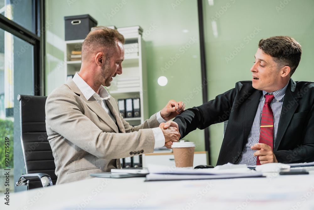 Caucasian middle-aged male businessperson and an Italian accountant are seated at a desk, engaging in a professional meeting, discussing various aspects of technology and innovation in their fields. Caucasian middle-aged male businessperson and an Italian accountant are seated at a desk, engaging in a professional meeting, discussing various aspects of technology and innovation in their fields.