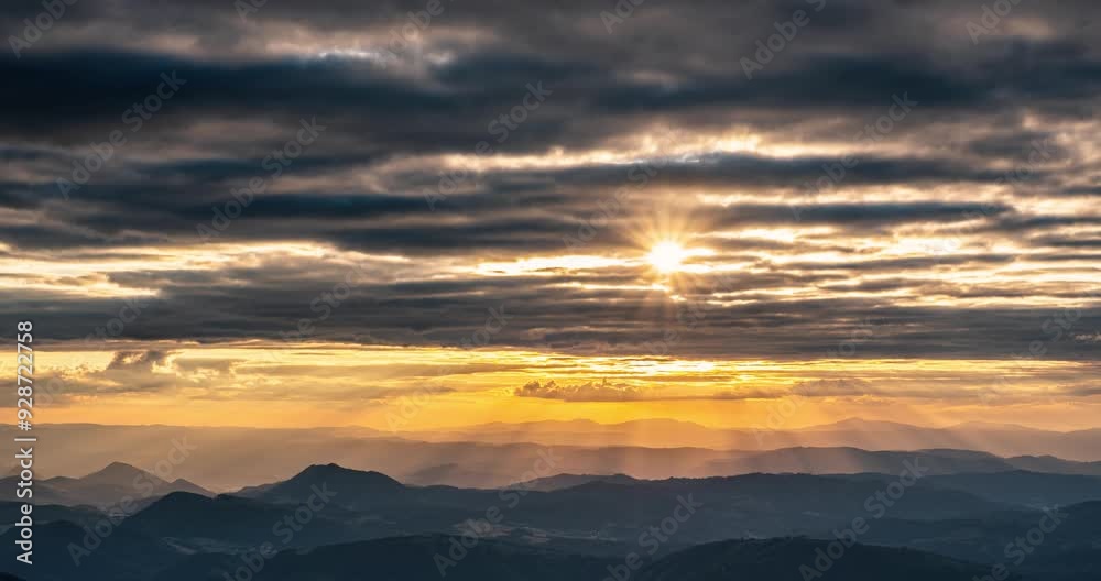 Beautiful sunrise in summer morning with golden rays of sun and clouds moving over mountains landscape Time lapse Beautiful sunrise in summer morning with golden rays of sun and clouds moving over mountains landscape Time lapse