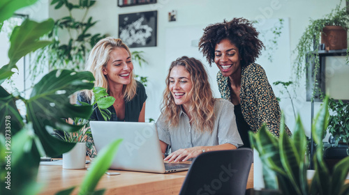 Three women working on laptop in the office