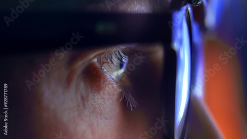 Eyes of Adult Man in Glasses Looking at Cyber Space on Computer Screen Close Up. Online Addiction of One Person in AR Eyewear with Artificial Intelligence. Eyeballs of Guy Browsing Internet 3D Network