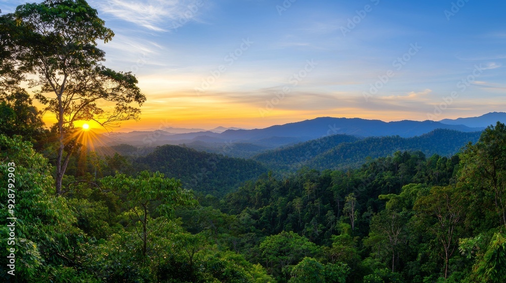 A beautiful mountain range with a bright orange sun in the sky A beautiful mountain range with a bright orange sun in the sky