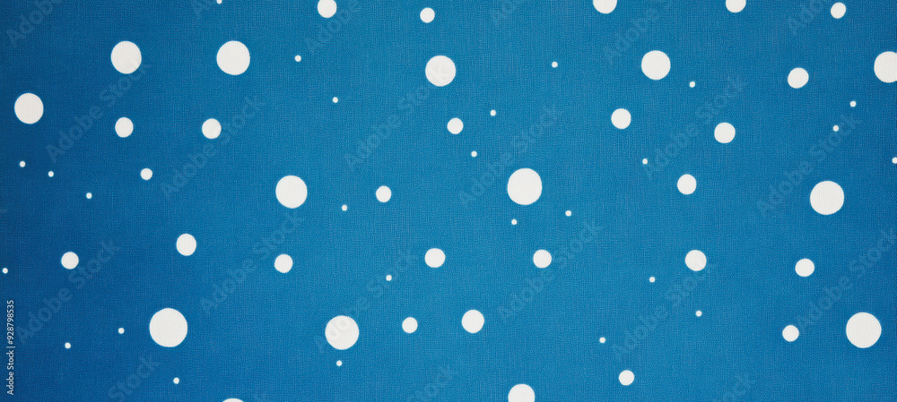 Blue winter backdrop with falling white snowflakes on a textured surface