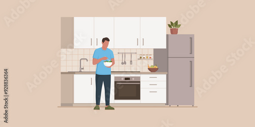 Healthy fit man in the kitchen, he is eating a fresh salad during a lunch break