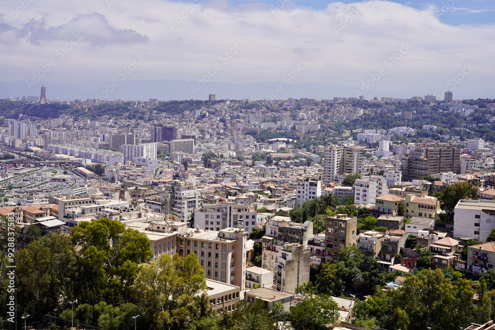 The densely packed skyscrapers of the city of Algiers reach far into the distance, as far as the eye can see, with the Monument to Martyrs on the horizon at the left. The densely packed skyscrapers of the city of Algiers reach far into the distance, as far as the eye can see, with the Monument to Martyrs on the horizon at the left.