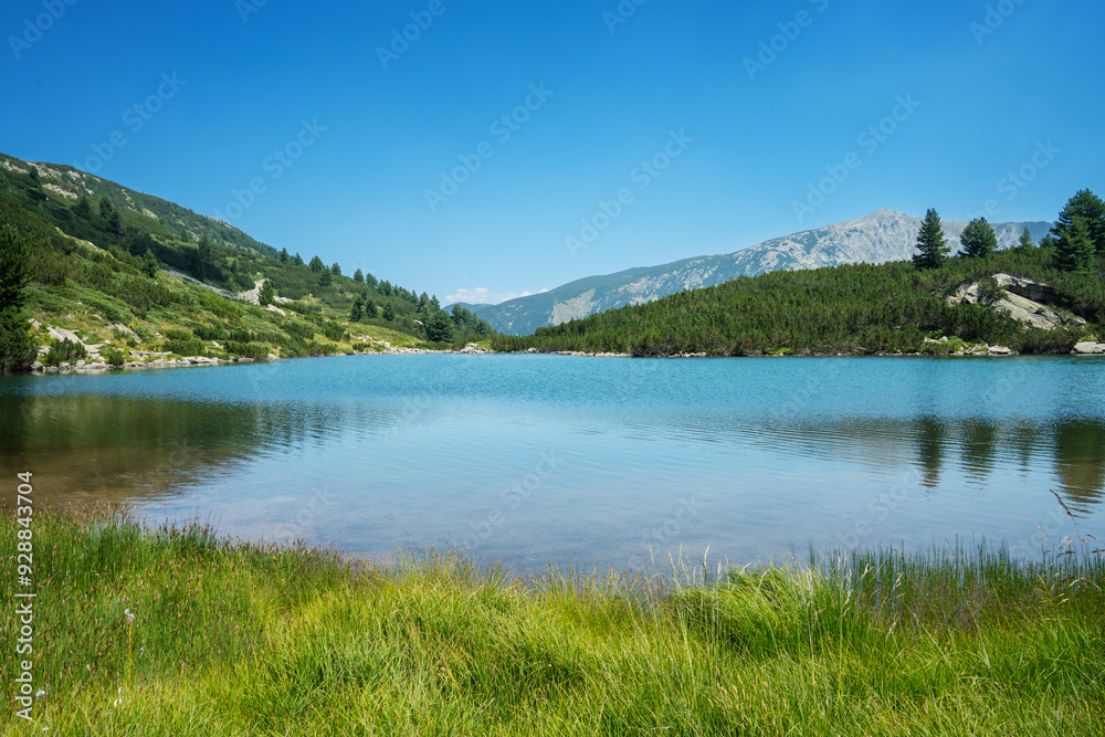 Pirin Mountains, August photo of Gorno Vasilashko Lake under clear blue sky.