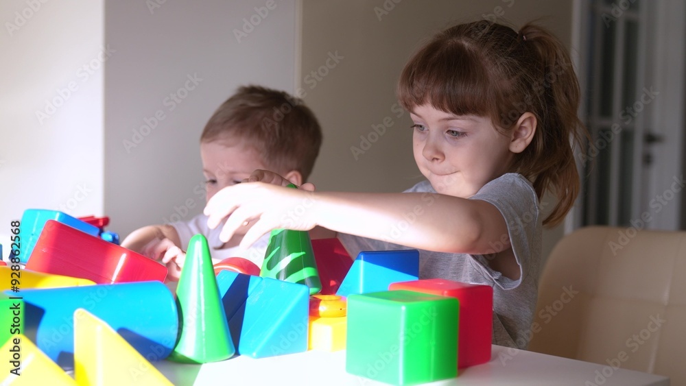 kids girl and baby indoor boy play in kindergarten. a group of children play toys cubes and cars on the table in kindergarten. happy family preschool education concept. nursery baby toddler home kids girl and baby indoor boy play in kindergarten. a group of children play toys cubes and cars on the table in kindergarten. happy family preschool education concept. nursery baby toddler home