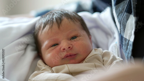 Close-up of newborn baby’s face resting on mother’s lap showcasing the delicate features and peaceful expression capturing the serene and intimate moments of early infancy in a loving home environment photo