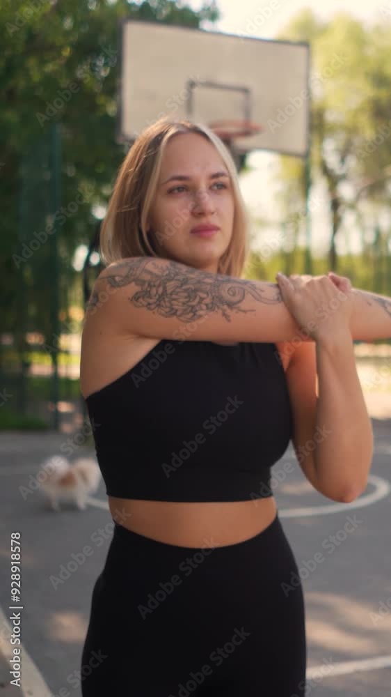 Beautiful young athletic girl in leggings with model figure on morning workout on basketball court on beach in summer. Fitness, warm-up and outdoor sports. Beauty and health Beautiful young athletic girl in leggings with model figure on morning workout on basketball court on beach in summer. Fitness, warm-up and outdoor sports. Beauty and health