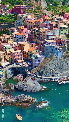 Vertical video of Manarola village in Cinque Terre, aerial view, vacation on Italian riviera, drone view of Cinque Terre, Manarola fishing village in Italy, holiday on Ligurian coast