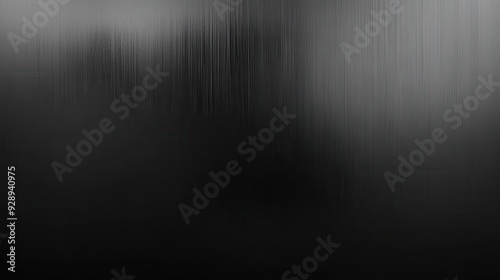 A blurred, dark abstract image with soft gradients and subtle texture.