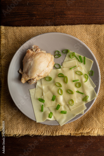 Thick meat broth, Dagestan khinkal thin dough, meat, on the table. photo