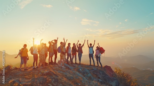 A vibrant group of hikers with raised arms celebrate the dawn on a mountain top, enveloped by the warm glow of the rising sun, capturing a moment of exhilaration.