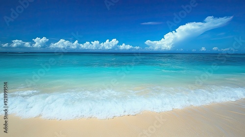 A breathtaking Caribbean beach scene, with turquoise waves gently lapping against the shore, under a cloudless blue sky.