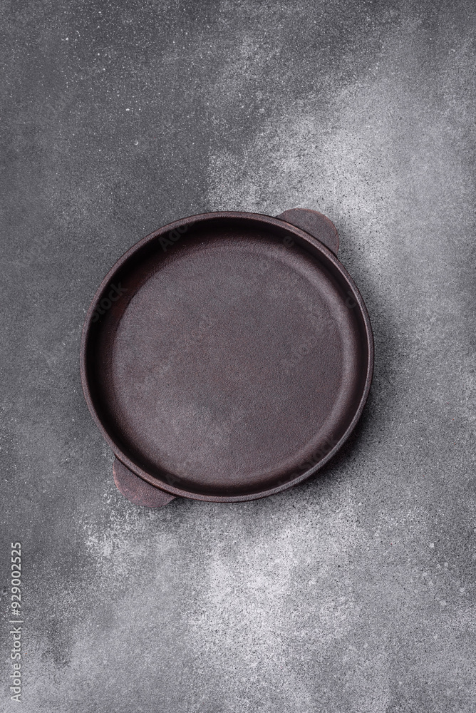 Empty ceramic plate on a dark textured background Empty ceramic plate on a dark textured background