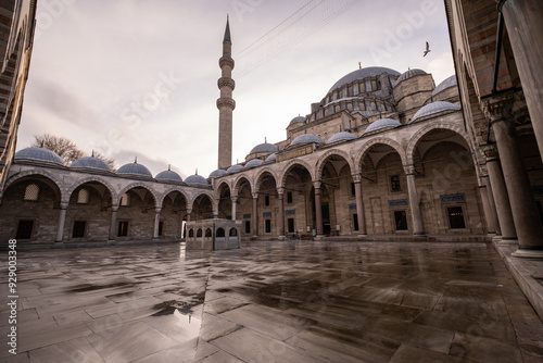 Awesome view of scenic gardens of the Suleymaniye Mosque in Istanbul, Turkey. The Ottoman imperial mosque is a popular destination among pilgrims and tourists of the world. photo